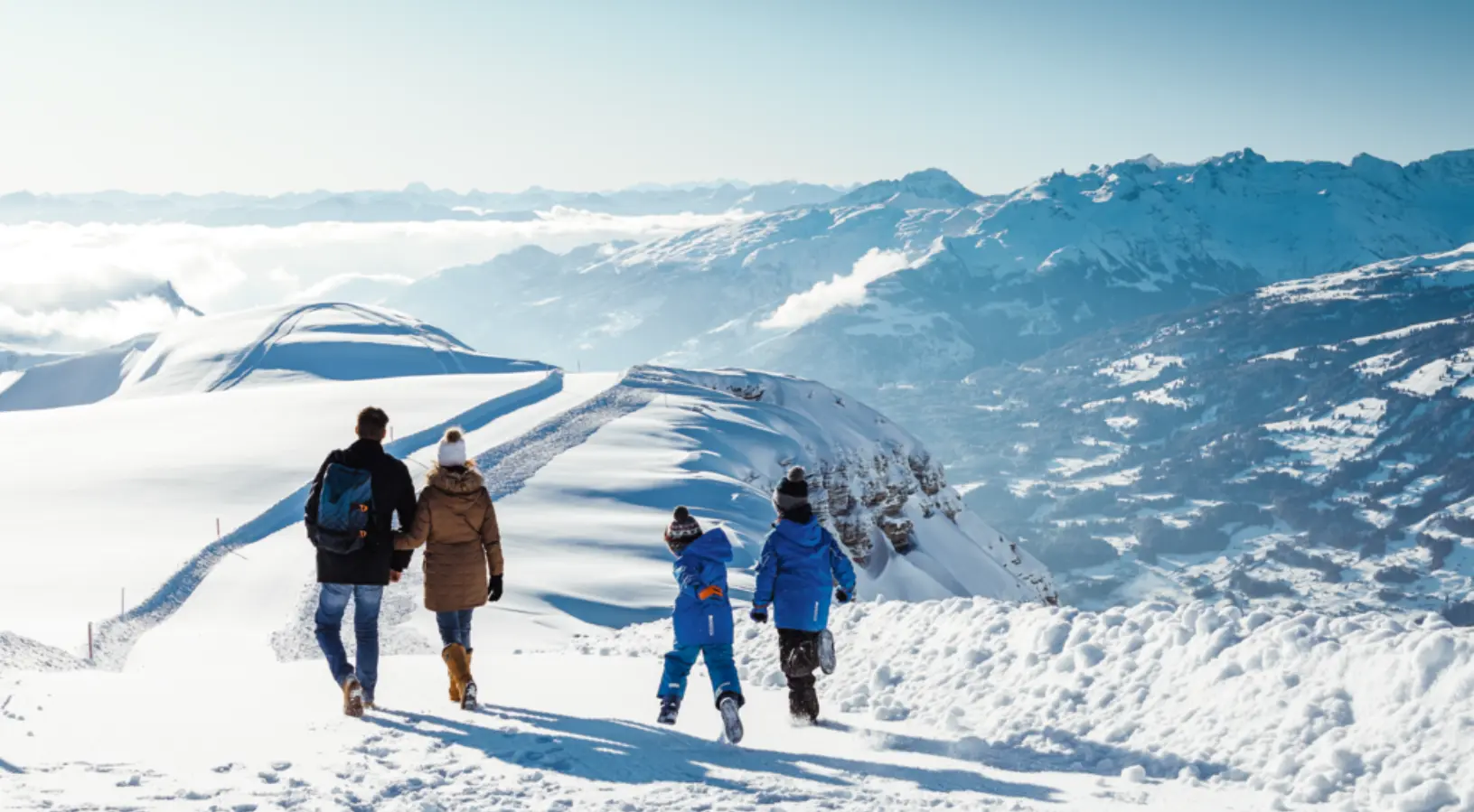 Family of four enjoying holidays in the snowy mountains, Excursions getting reasonable discounts through the Swiss Travel Pass